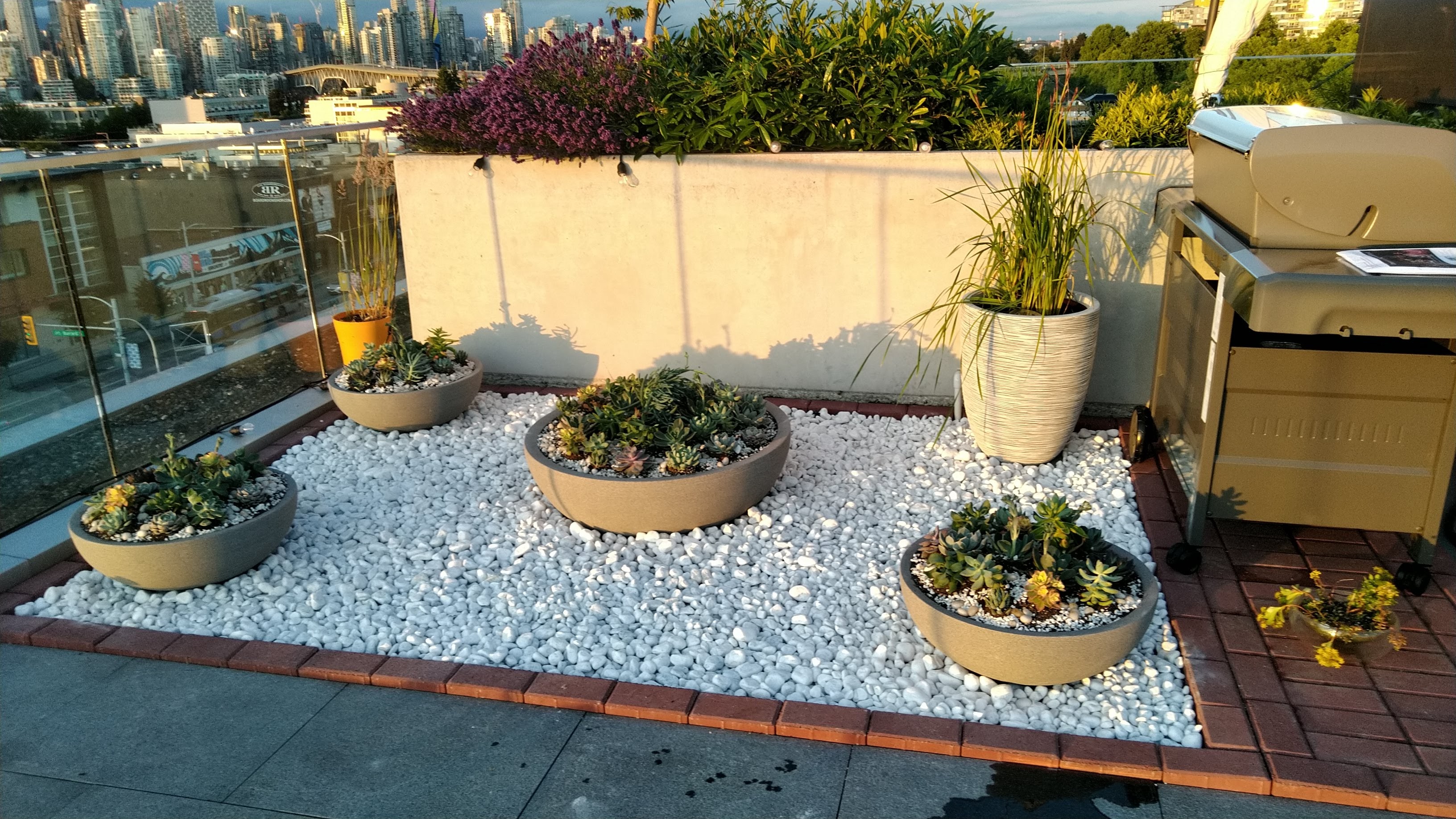 White rock garden bed with flower pots Vancouver